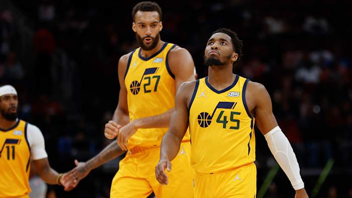 Utah Jazz guard Donovan Mitchell (45) and center Rudy Gobert (27) react after a play during the third quarter against the Houston Rockets.
